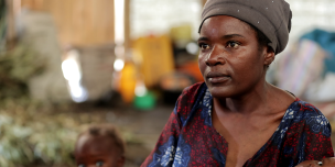 Feza Damani, mother of seven, fled the village of Kiwanja in the Rutshuru region. She has been living in Rusayo since September 2023. Mrs Feza and her seven children now live in a communal warehouse with several other displaced people. Photo credit: Yves Kalwira/ Oxfam Feza Damani, mother of seven, fled the village of Kiwanja in the Rutshuru region. She has been living in Rusayo since September 2023. Mrs Feza and her seven children now live in a communal warehouse with several other displaced people. Photo credit: Yves Kalwira/ Oxfam