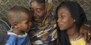 Refugees fleeing the Sudan conflict, Saud Yosif Idris Mahmou, 40, and her children Asia* and Hassan* at their shelter at the transit center in Renk. Photo: Peter Caton/Oxfam