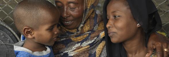 Refugees fleeing the Sudan conflict, Saud Yosif Idris Mahmou, 40, and her children Asia* and Hassan* at their shelter at the transit center in Renk. Photo: Peter Caton/Oxfam