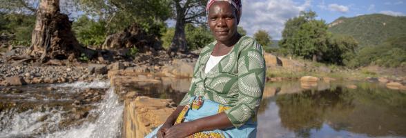 Sarah checks the water level at Nyanyadzi river,  Zimbabwe. She has been farming for 25 years. "A lot has changed since I started farming. The rain now comes late". Photo credit: Cynthia Matonhodze/Oxfam