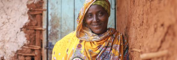 Madina Mohamed, program participant of the water project in Isiolo County where MID-P in partnership with Oxfam is constructing water point, borehole and tank and giving out 120 liters tank for storage fetches water in a river. Photo Credit: Eyeris Communications/Oxfam