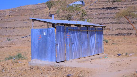 Oxfam repaired this latrine in Hitsats, helping reduce open defecation and improve sanitation for families living in the site. 
