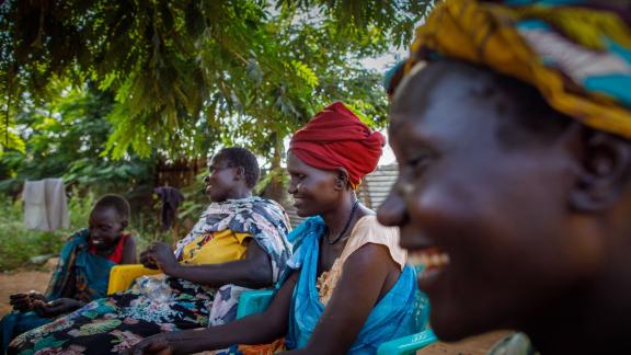 42-year-old Nyawouw Mayok, a female leader at Gambella refugee camp, engages in a discussion with a group of women outside her house, addressing pertinent issues affecting women in the camp. Photo credit: Petterik Wiggers/ Oxfam
