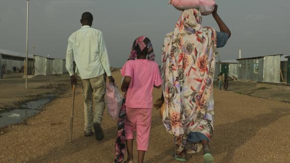 Khamis Adam Mohammed, 33, arrives at the transit centre in Renk and greets his family after arriving from war torn Sudan. credit: Peter Caton/Oxfam