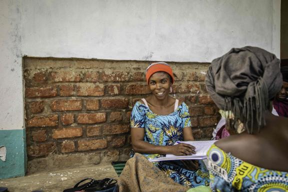Murega Bahat accurately count the money from the A.V.E.C savings group in Burhinyi chiefdom, South Kivu, DRC.