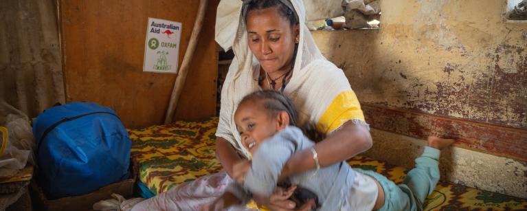 Netsanet, a participant in the Oxfam support program spending time with her daughter at their makeshift home in Tigray, Northern Ethiopia. Photo credit: Petterik Wiggers/Oxfam