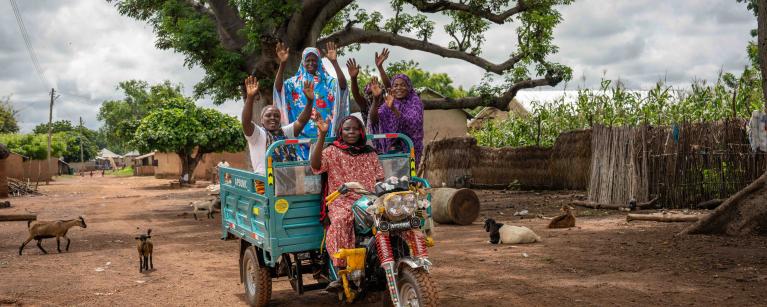 Members of the Tungteiya Women’s Association Shea Butter Processing Center, Diaré rely on the new tricycle they received from Oxfam to help them access markets and move their produce around more easily.