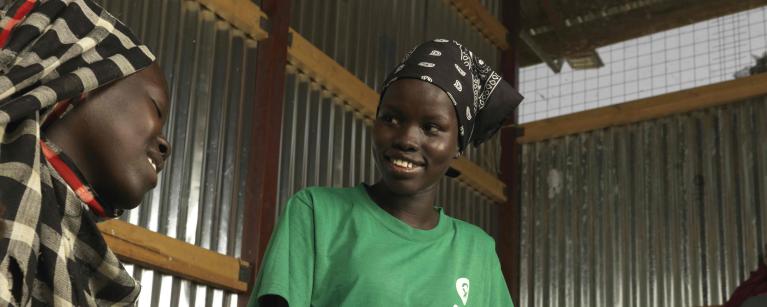 Oxfam staff in Renk Nyamer Gabriel Nagjwok speaking to Achol Ring, a refugee displaced by conflict in Sudan about the importance of sanitation to prevent diseases.