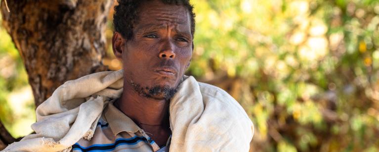 49 year-old Gebrezgabiher Habtu stares at his crops after they all failed due to the ongoing drought in Tigray. CREDIT: Zerubabel Tore/Oxfam