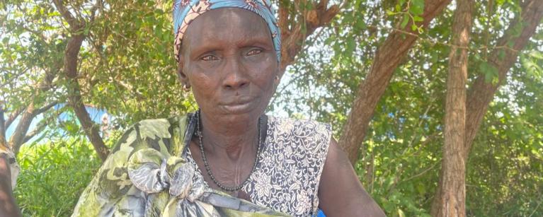 , Rebecca Korok, a mother of eight. In 2020, Rebecca faced unimaginable challenges as her family's farms were burned, properties destroyed, and cattle raided. Photo credit: Kapuki Henry/ Oxfam