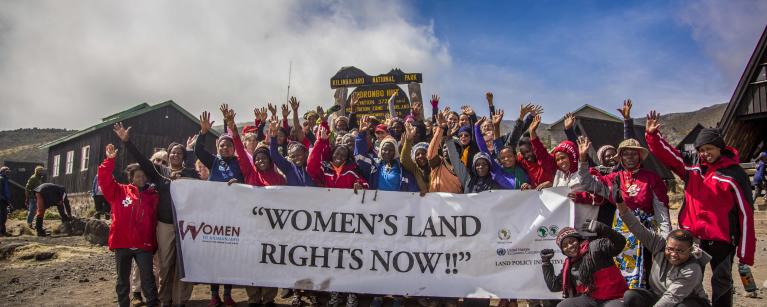 A group of rural women farmers and their supporters stand at the summit of Mount Kilimanjaro, using the climb as a powerful symbol of challenging and overcoming land inequalities around the world. Credit: Amy Bolger & Brad John-Davis, 2016
