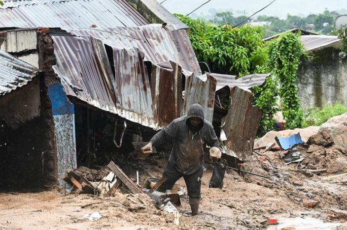 A man in Chilobwe Township in Blantyre picking something from the rubble of his house after mudslides, heavy rains and winds destroyed it. Photo credit: Thoko Chikondi/ Oxfam