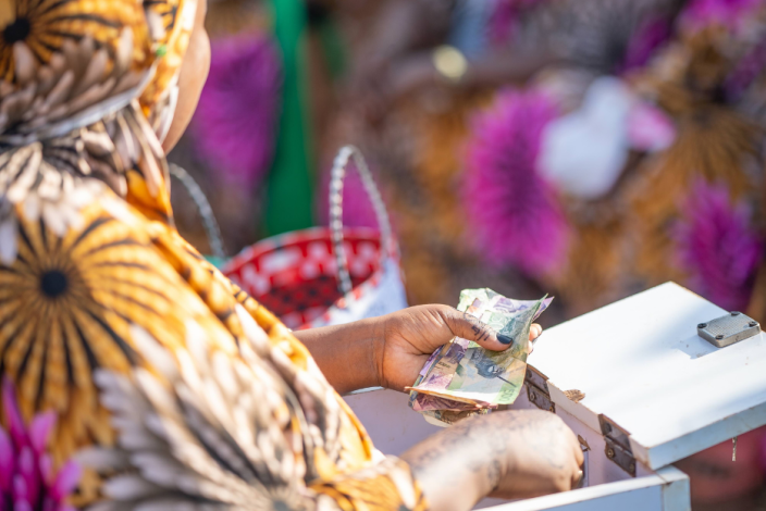 Halima Abdo of Manyatta Konso Women's Group, Marsabit County, reconciling Village Savings and Loan contributions.