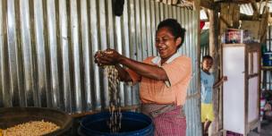 Oecusse, Timor-Leste: Sabina Foni shows her corn harvest that was recently picked from her permanent garden supported by Oxfam's Strengthening Community Livelihoods (Haforsa) Program.