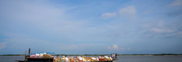 A small mechanized boat carries local trade commodities in Dhubri, Assam. Photo: Sailendra Yashwant/ Oxfam India