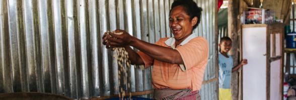 Oecusse, Timor-Leste: Sabina Foni shows her corn harvest that was recently picked from her permanent garden supported by Oxfam's Strengthening Community Livelihoods (Haforsa) Program.