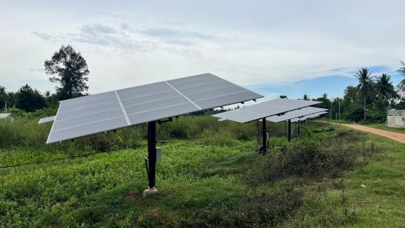 A few kilometers from the water pump station, solar panels line a reservoir that the commune hopes to use as a water source during droughts. Commune members say additional infrastructure investments are needed to make this possible. Photo by Vin Aranas/I-JET