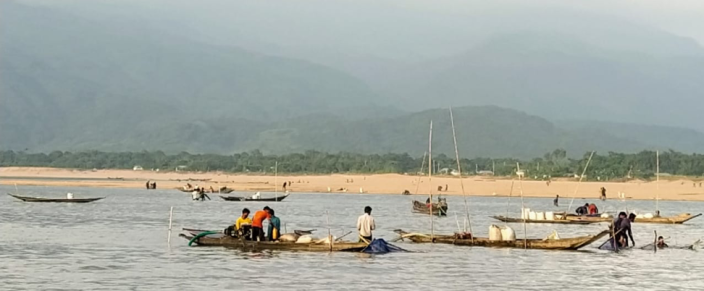 Labourers lifting sands from Jadukatha river in Sunajgonj. Backdrop: Meghalaya hills upstream.