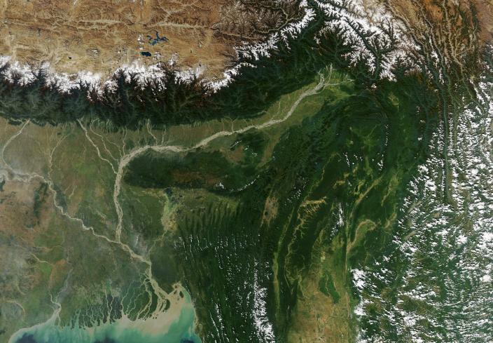 The Brahmaputra is a river of many names. In its upper courses, where it winds through a maze of narrow gorges in Tibet, it is the Yarlung Tsangpo. After a hairpin turn near Namche Barwa, it becomes the Siang. As it cascades through the Himalayan foothills in the northeastern Indian state of Arundal Pradesh, it is called the Dihang. People start calling it the Brahamputra as it widens and flows through Assam. After crossing into Bangladesh and absorbing the flow of several tributaries, it becomes the Jamuna River, then the Padma, and finally the Meghna before pouring into the Bay of Bengal. A natural-color image of the Brahmaputra river.