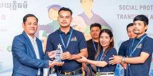 The first winning group, Ms. Pisey Som, Mr. Touch Pov, Mr. Chantha Mok, received their award during the award reception presented by H.E.Dr. Sophannarith Heng, Deputy Director General of the National Social Security Fund, Ministry of Labour and Vocational Training. Photo: Oxfam