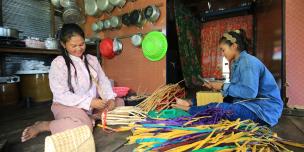 Roth Chhay (left) while making hyacinth handbag. Photo: Oxfam