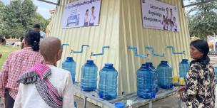 A displaced community happily collecting treated water from the newly constructed water station, located in Wat Bo Khnar Techo. Photo: Hojin Shin/ Oxfam
