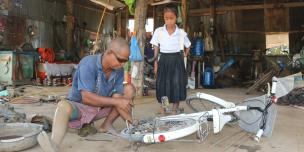 Rachna at repair shop to have her bicycle fixed. 