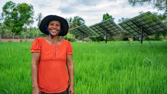 Thea Bou standing in front of Solar Irrigation System in Kandieng district which is managed and operated by the local communities. Thea Bou standing in front of Solar Irrigation System in Kandieng district which is managed and operated by the local communities.
