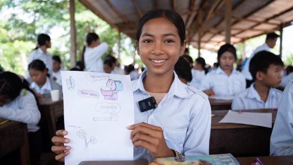 Sotha Tham, a student from Romdoul Secondary School, shared her illustration on safe drinking water and hygiene practices during an interactive drawing competition. “Safe water and clean water are different; clean water can be used for cooking or bathing, but safe water can be consumed daily,” said Sotha. Photo: Oxfam