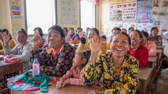 Parents and community members attend an awareness session at a local school, learning about the health benefits of safe, locally treated Kuchsar water and the importance of clean drinking water for their families. Photo: Oxfam
