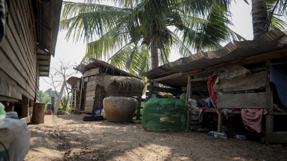 Ratana’s modest home stands beside a small chicken coop, where his surviving flock is raised as the family works to rebuild their livelihood.