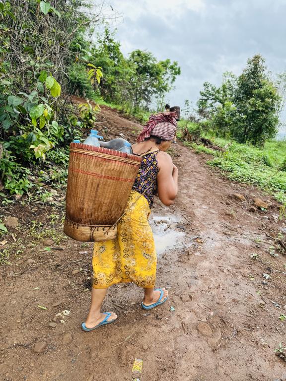 Indigenous community making their daily trek down the hillside to collect water for their daily consumption.  Photo: Soknak Por/Oxfam