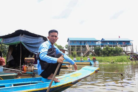 Mr. Teav Piseth, President of Kbal Taol Primary School Sitting on a boat in front of a primary school Mr. Teav Piseth, President of Kbal Taol Primary School Sitting on a boat in front of a primary school