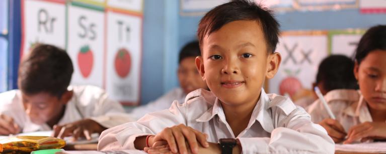 Chhong Chhenghun, studying with his fifth-grade classmates at Kampong Plouk Primary School, Siem Reap province, Cambodia.