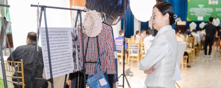 Ms. Chan Chhorvy Sok, Oxfam Program Manager, during the ‘White Tear‘ exhibition. These are materials and stories from women working at the rubber and banana plantations.