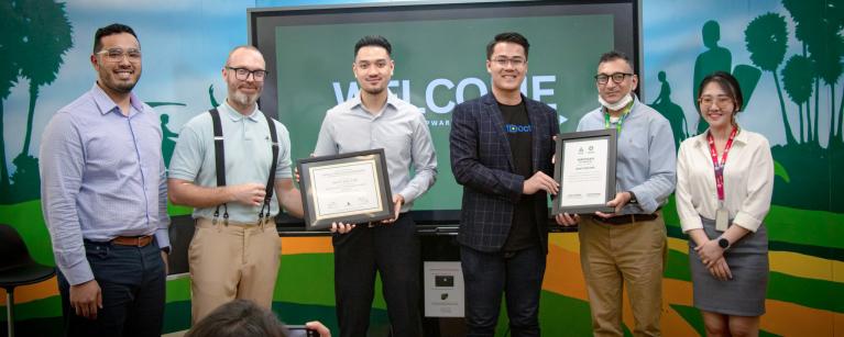 The presentation of certificates of completion to businesses that successfully completed the Impact Innovators Program.