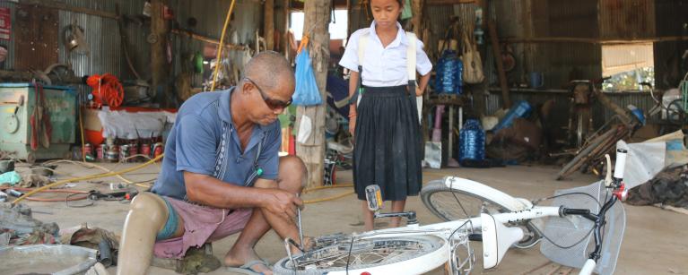 Rachna at repair shop to have her bicycle fixed. 