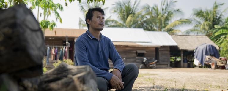 A month home, Ratana surveys the fragile yard that holds the cart, the chickens, and memories of months that changed everything