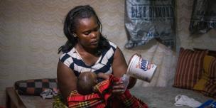 Elizabeth Wayua,31, a domestic worker feeds the baby of her employer in Pipeline, Embakasi, Nairobi, Kenya. 2016. Photo Credit/Allan Gichigi