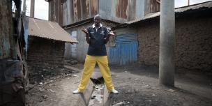 Volunteer Azulu Adeba, 44, describes the poor drainage in his community, where he carries out tax monitoring work with the National Taxpayers Association in Kiambiu, Eastleigh, Nairobi, Kenya. 2016. Photo Credit: Allan Gichigi