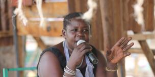 A woman trader contributing during a live radio show on oil and community rights in Lodwar, Turkana. Photo Credit: LightBox Limited