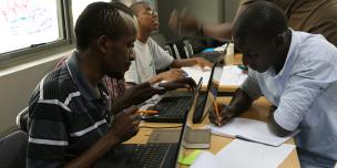 Hackers and CSO members discussing a budget monitoring system during a hackathon. Photo Credit: Joyce Kabue