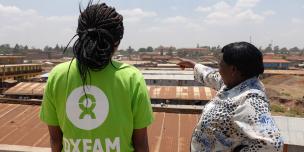 Jane Muthoni describing her local area and pointing out poor public services in the community. Kawangware, Nairobi, Kenya. Photo Credit: Allan Gichigi
