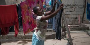 Tabitha Mwikali, 36, a domestic worker hanging clothes for her employer in Eastleigh, Nairobi, Kenya. 2016