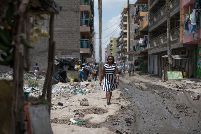  Elizabeth Wayua, 31, a domestic worker arrives at her employer's house to start her chores in Pipeline, Embakasi, Nairobi, Kenya. 2016. Photo Credit: Allan Gichigi