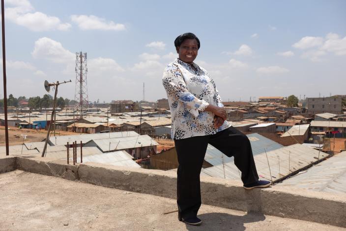 Jane Muthoni, 50, on the roof of her building in Kawangware, Nairobi, Kenya 2016. Photo Credit: Allan Gichigi