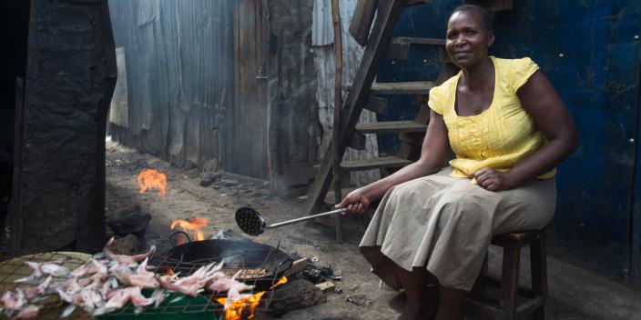 Zipporah Kwamboka preparing fish for her business in Mukuru informal settlements, Nairobi, Kenya.  She has benefited from Oxfam Cash transfer for work program. Photo Credit: Allan Gichigi / Oxfam