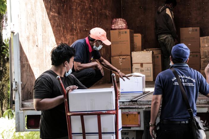 Delivery team load Covid-19 relief materials on to truck at Oxfam office.