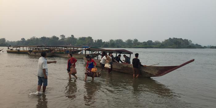 crossing the Mekong river by boat