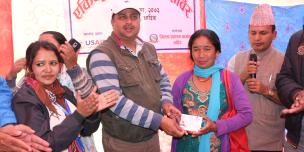 Bimala Nepali receiving citizenship certificate from Dhading's Chief District Officer, Umesh Kumar Dhakal. Photo by: Sarita Rai/Oxfam